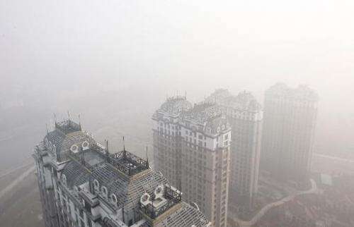 Buildings and streets are seen shrouded in heavy smog in Harbin, China's Heilongjiang province, on October 22, 2013
