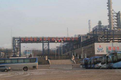 Buses stop outside the Dalian Fujia Dahua Petrochemical factory in Dalian, China on January 18, 2013
