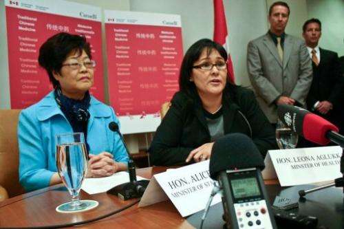 Canadian Health Minister Leona Aglukkaq (R) and the Canadian minister of state (L) speak on October 14, 2011, Vancouver