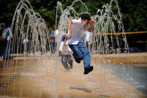 Children play in a water fountain to cool down in Medellin, Antioquia, Colombia in September 11, 2009