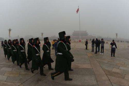 Chinese military police march through Tiananmen Square blanketed in pollution in Beijing on January 30, 2013