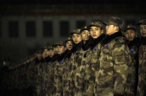 Chinese soldiers prepare to watch the daily flag-raising on Tiananmen Square in Beijing on January 1, 2013