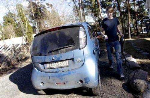 Christian Blakseth, who traded his bicycle for an electric car, charges his vehicle's batteries, in Oslo, on April 18, 2011