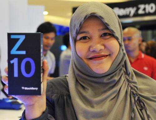 Diana Monasapti shows the Blackberry Z10 she bought at its launch in Jakarta on March 15, 2013