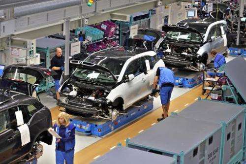 Employees of German carmaker BMW work on the production of the new electrical vehicle i3 at the plant in Leipzig, eastern German