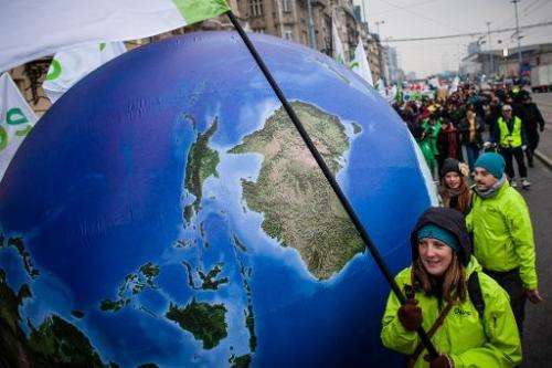 Enviromental activists march demanding more climate saving actions during UN climate change talks on November 16, 2013