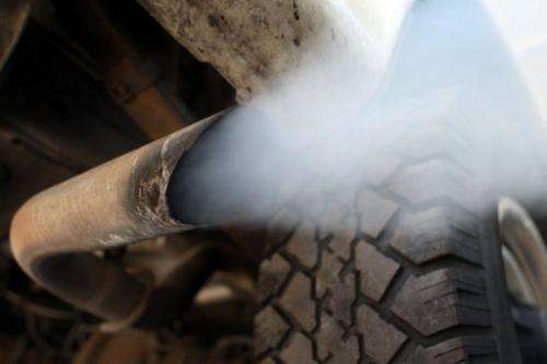 Exhaust flows out of the tailpipe of a vehicle at &quot;Mufflers 4 Less&quot; in Miami, Florida, on July 11, 2007