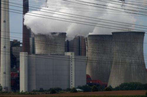 Exhaust rises from cooling towers of a coal-fired power station at Grevenbroich near Aachen on September 11, 2012