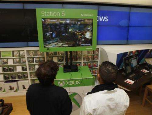 Fans play a game at a Microsoft retail store in Houston, Texas, on November 21, 2013