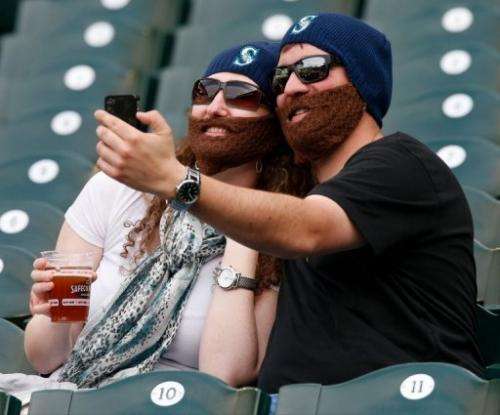 Fans take a self portrait wearing faux beards in Seattle, Washington on  26, 2013