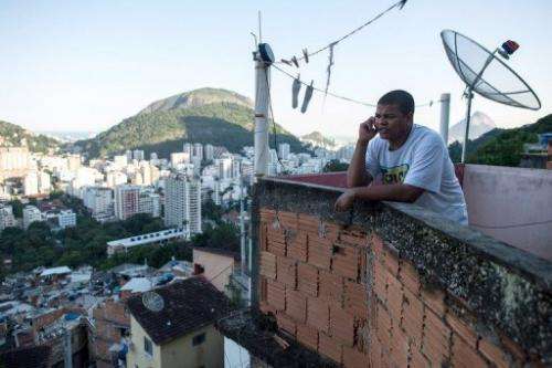 Favela tour guide Thiago Firmino speaks on his cell phone in Santa Marta shantytown in Rio de Janeiro on June 11, 2013
