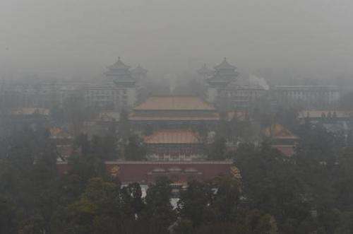 File photo of Beijing's famous Guotai Chambers in Jingshan Park covered in smog