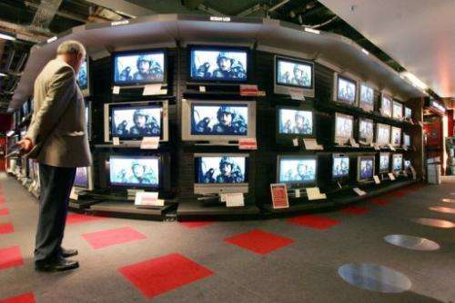 File picture for illustration shows a customer looking at television setsin a department store