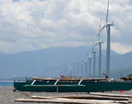 Fishing boats anchored next to wind turbines on Bangui Bay in Ilocos norte, north of Manila, on May 4, 2013