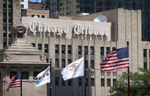 Flags fly along the Michigan Avenue bridge near the Tribune Tower, home of the Chicago Tribune, WGN Radio and the Tribune Compan