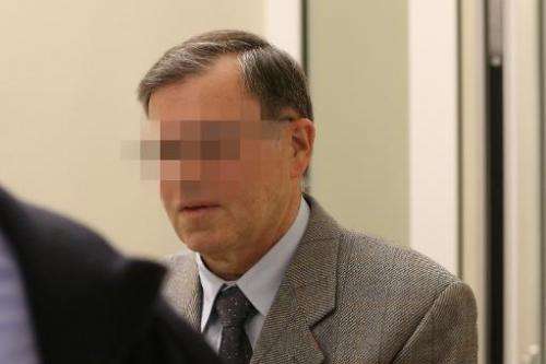 Former NATO employee identified as Manfred K arrives on November 5, 2013 at the courthouse in Koblenz, western Germany, for his 