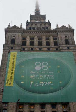 Greenpeace activists in Warsaw hang a banner calling for the release of remaining members held in Russia over a protest in the A