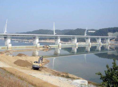 Heavy equipment is seen being used to construct the Gangchon bridge and weir in Yeoju, on October 8, 2011