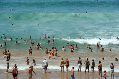Holidaymakers take a dip in the sea at a beach in Biarritz, southwestern France, on July 31, 2013 as temperature soar