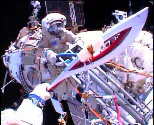 In this image obtained from NASA TV, Cosmonauts Oleg Kotov and Sergei Ryazansky (rear) perform a handoff of the Sochi 2014 Winte