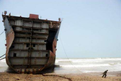 In this photograph taken on July 10, 2012, a Pakistani worker is seen in one of the 127 ship-breaking plots in Geddani