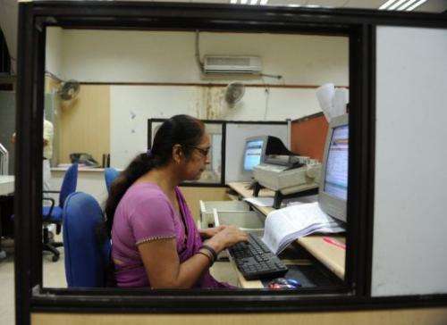 In this picture taken on July 10, 2013 a worker types a telegram at the Central Telegraph Office in New Delhi