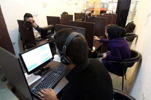 Iranians surf the net at a cyber at a cafe in Tehran on in 2011
