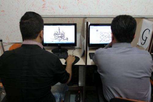 Iranians use computers at a cybercafe in Tehran, on May 14, 2013