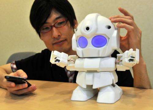 Japanese engineer Shota Ishiwatari displays the robot &quot;Rapiro&quot; which works with a &quot;Raspberry Pi&quot; in Tokyo, J
