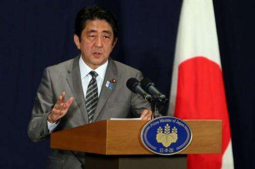 Japanese Prime Minister Shinzo Abe attends a press conference in Doha on August 28, 2013