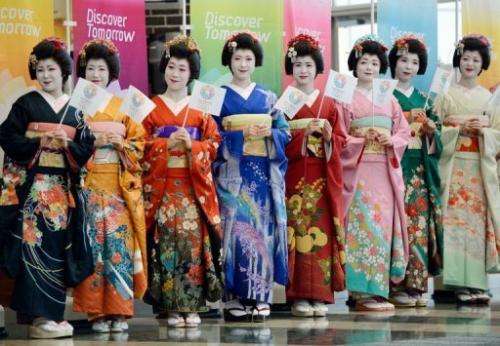 Japanese women clad in maiko costumes welcome members of the IOC in Tokyo on March 6, 2013