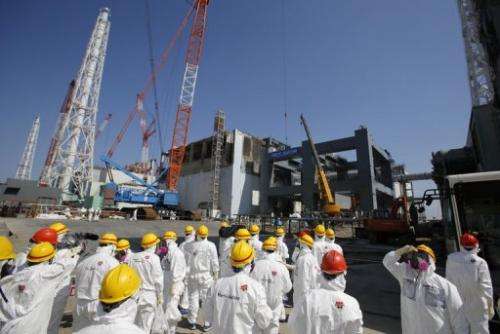 Journalists wear protective suits at the tsunami-crippled Fukushima Dai-ichi nuclear plant in Japan on March 6, 2013