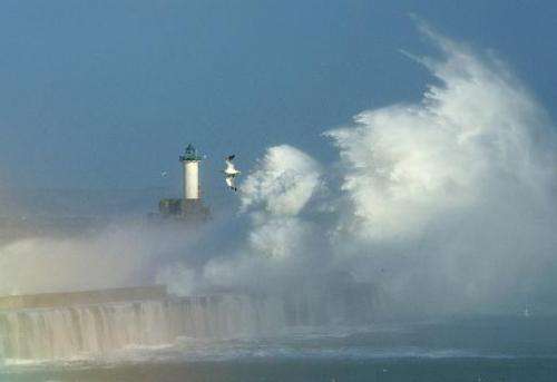 Large waves break against the dyke at the the port of Boulogne, northern France, on October 28, 2013 as storms hit swathes of Eu