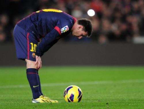 Lionel Messi concentrates prior to a penalty kick at the Camp Nou stadium in Barcelona on January 6, 2013