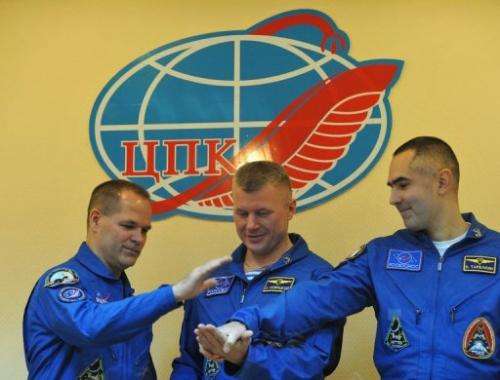 (L-R) US astronaut Kevin Ford and  Russian cosmonauts Oleg Novitskiy and Evgeny Tarelkin, pose October 22, 2012