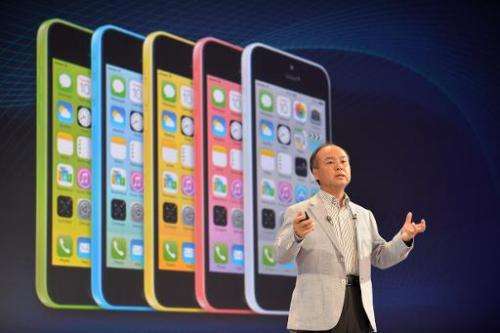 Masayoshi Son, chairman and CEO of Japan's SoftBank Corp, introduces Apple's iPhone 5c, during a press briefing in Tokyo, on Sep