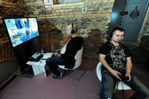 Men play Assassin's Creed on September 29, 2011, in Istanbul