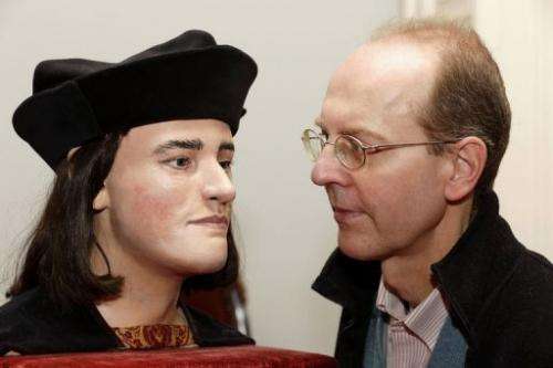 Michael Ibsen, a descendant of England's king Richard III, with a plastic model based on a CT scan the king's skull