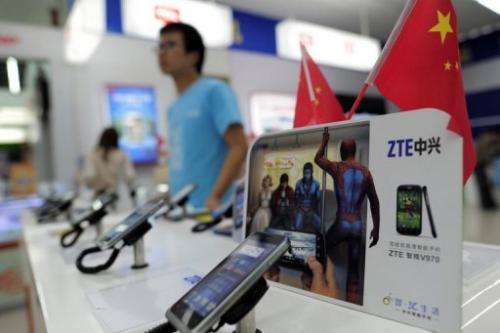 Mobile devices are displayed on a ZTE sales counter in Wuhan in central China's Hubei province on October 8, 2012
