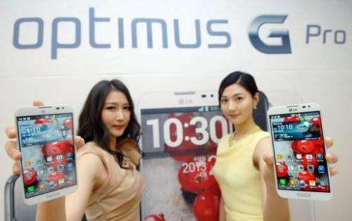 Models are pictured holding the Optimus G Pro smartphone during a press conference in Seoul on February 18, 2013