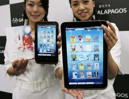 Models display Sharp's line of Galapagos tablet comptuers in Tokyo on November 29, 2010