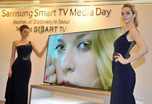Models present Samsung's 75-inch F8000 Smart LED TV during a media conference in Seoul on February 19, 2013