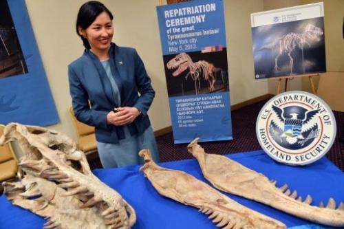 Mongolian Minister of Culture, Sport and Tourism Oyungerel Tsedevdamba poses with part of the skeleton