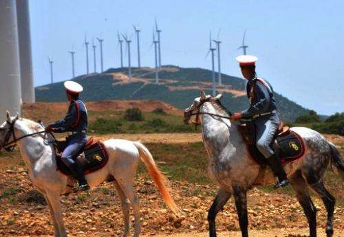 Moroccan guards ride past the Dahr Saadane wind farm in Tangiers on June 8, 2010