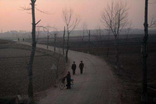 North Koreans are seen from a train on a line between Pyongyang and the North Phyongan Province,  April 8, 2012.