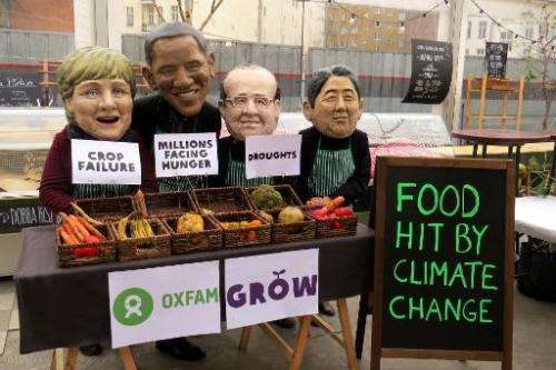 Oxfam protesters wear masks depicting (from left) German Chancellor Angela Merkel, US President Barack Obama, French President F