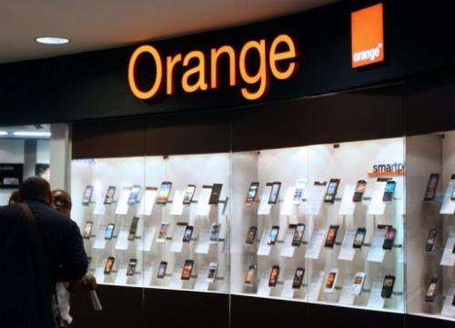People are seen in an Orange store on July 19, 2012 in Paris