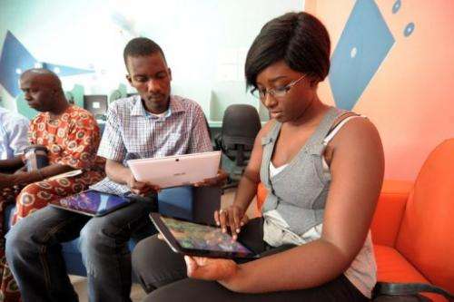 People browse the Internet using tablets, during the opening of &quot;Tablette Cafe&quot;, on May 27, 2013, in Dakar
