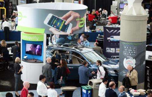 People crowd around a Nissan Rogue loaded with Airbiquity technology on November 19, 2013 in Los Angeles, where the LA Auto Show