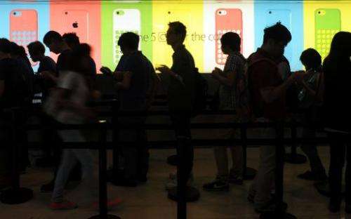 People queue outside an Apple store to purchase the iPhone 5s and 5c in Hong Kong on September 20, 2013